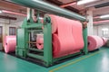 Fiberglass insulation production line, with machinery creating pink batts for residential and commercial use
