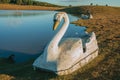 Fiberglass pedal boat resembling swan near lake