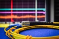 Fibre optic cable with spectrum analiser in the background Royalty Free Stock Photo