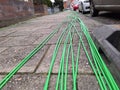 Fibre optic cables ready on the pavement to be buried for high-speed internet Royalty Free Stock Photo