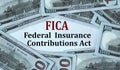 FICA - acronym on the background of cash dollar bills Royalty Free Stock Photo
