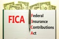 FICA symbol. Concept words FICA federal insurance contributions act on white note on beautiful white background. Dollar bills. Royalty Free Stock Photo