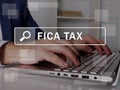 FICA TAX Federal Insurance Contributions Act text in search line. Broker looking for something at computer. FICA TAX Federal