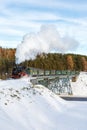 Fichtelbergbahn steam train locomotive railway on a bridge in winter portrait format in Oberwiesenthal, Germany Royalty Free Stock Photo