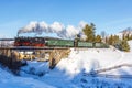 Fichtelbergbahn steam train locomotive railway on a bridge in winter in Sehmatal, Germany Royalty Free Stock Photo