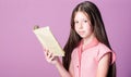 Fiction and nonfiction. Cute small child reading book on violet background. Thirst of knowledge. Adorable bookworm