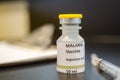 Malaria vaccine vial with a syringe