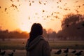 Fictional Silhouette of a girl in a background of a flock of pigeons. Royalty Free Stock Photo