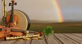 Fiddle bodhran and shamrock with a distant rainbow Royalty Free Stock Photo