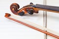 Fiddle bow and scroll on music book Royalty Free Stock Photo