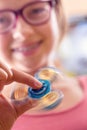 Fidget Spinner. Cute young girl playing with fidget spinner Royalty Free Stock Photo