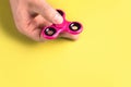 Fidget spinner in hand. Colorful trend toy.