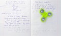 Fidget spinner stress relieving toy on notebook background Royalty Free Stock Photo