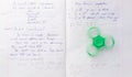 Fidget spinner stress relieving toy on notebook background