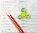 Fidget spinner stress relieving toy on notebook background Royalty Free Stock Photo
