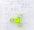 Fidget spinner stress relieving toy on notebook background
