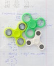 Fidget spinner stress relieving toy on notebook background Royalty Free Stock Photo