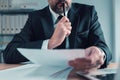 Fiduciary, agent carefully reading business papers in office