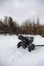 Field gun covered with snow at the edge of a forest Royalty Free Stock Photo