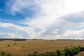 Field and clouds with hay bales