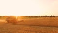 Field and combine at sunrise. Royalty Free Stock Photo