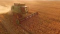 Field with combine at sunrise. Royalty Free Stock Photo