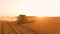 Field with combine at sunrise. Royalty Free Stock Photo