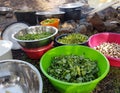 Field cooking- edible plants in bowels and puts on the fire Royalty Free Stock Photo