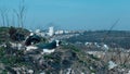 Field covered with garbage and plastic bags thrown and scattered by the wind at the city background