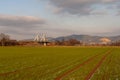 Field of crops at early spring with view of a bridge and hills during golden sunset near Heidelberg, Germany, reddish sundown Royalty Free Stock Photo