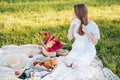 Field in daisies, a bouquet of flowers.French style romantic picnic setting. Woman in cotton dress and hat Royalty Free Stock Photo
