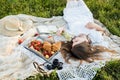 Field in daisies, a bouquet of flowers.Summer picnic by the sea. basket for a picnic with with buns, apples and juice Royalty Free Stock Photo