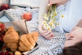 Field in daisies, a bouquet of flowers.Summer picnic by the sea. basket for a picnic with with buns, apples and juice Royalty Free Stock Photo