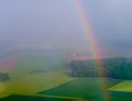 Bright rainbow over the agricultural field