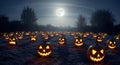A field filled with carved pumpkins, each glowing from within, featuring typical jack- Royalty Free Stock Photo