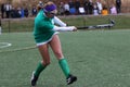 The field hockey player takes a shot at the goal.