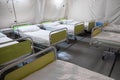 Field hospital tent with beds.