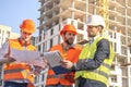 Field Inspectors and manager at Building Construction Site checking blueprints Royalty Free Stock Photo