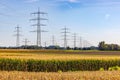 Field with many electricity pylons and lines as a power line Royalty Free Stock Photo