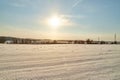 Field, meadow and grass with snow and cold sun on foggy cloudy sky. Beautiful winter landscape. Winter morning, day or Royalty Free Stock Photo