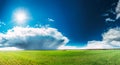 Field Or Meadow Landscape With Green Grass Under Scenic Spring Blue Sky With White Fluffy Clouds And Shining Sun Royalty Free Stock Photo