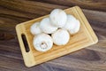 Field mushrooms on a cutting board Royalty Free Stock Photo