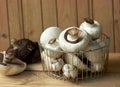 Field mushrooms in the steel kitchen basket on rustic wooden table and background Royalty Free Stock Photo