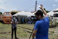 Field news reporter and vlogger working on their gears during the arrival of President Rodrigo R. Duterte to inaugurate the openin