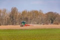 A field is plowed by a tractor with plow in winter sunshine Royalty Free Stock Photo