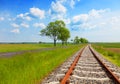 Field with railway rails, roads and blue sky. Landscape of the periphery