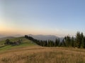 Field road on the mountain near the forest. Carpathian mountains in a summer evening, view into the distance. Mountain range at Royalty Free Stock Photo