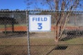 Field 3 sign on chain link fence from distance Royalty Free Stock Photo