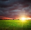 Field and sky with heavy dark clouds