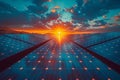 A field of solar panels glowing as the sun sets behind the clouds in the sky Royalty Free Stock Photo